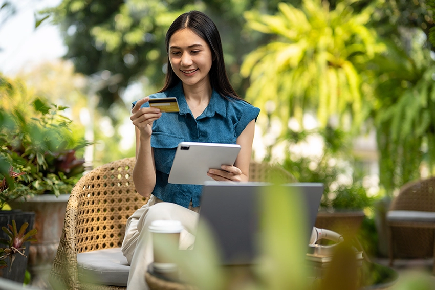 lady sitting down holding a credit card